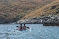 Tourist kayaking at Himara rocky shore