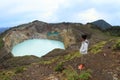 Tourist on Kelimutu watching unique lakes Tap and Tin Royalty Free Stock Photo