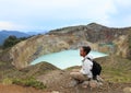 Tourist on Kelimutu watching unique lakes Tap and Tin