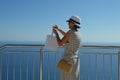 Tourist lady taking a scenic photo at panorama point