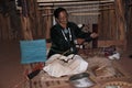 Tourist learning about the Navajo Way of Life including hair braiding and weaving