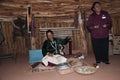 Tourist learning about the Navajo Way of Life including hair braiding and weaving