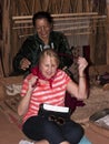 Tourist learning about the Navajo Way of Life including hair braiding and weaving