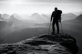 Tourist with leg in immobilizer. Hiker silhouette with medicine crutch on mountain Royalty Free Stock Photo