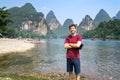 Tourist by the Li river in Yangshuo, China