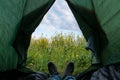 A tourist living in a tent with a view of canola field and a cloudy sky, Royalty Free Stock Photo