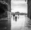 Tourist and locals people walking by the venetian street after the heavy rain in Venice, Italy