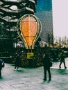 Tourist and locals taking pictures and posing next to a decorative hot air toy balloon.