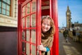 Tourist in London looking out of the phonebox Royalty Free Stock Photo