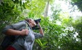 Tourist looking through binoculars exploring the wild birds in t Royalty Free Stock Photo