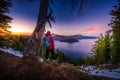 Tourist looking at Crater Lake Oregon Landscape