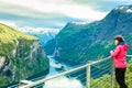 Tourist looking at Geirangerfjord from Flydasjuvet viewpoint Norway Royalty Free Stock Photo