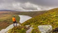 Tourist is looking at the Glendalough Valley, Male hiker enjoying the view Royalty Free Stock Photo