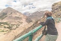 Tourist looking at Inca terraces of Pisac, Peru, filtered image