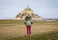 Girl watching the Mont Saint Michel Normandy France.