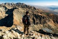 Tourist looking on mountains from top of the peak. View from hill Krivan in High Tatras mountains, Slovakia Royalty Free Stock Photo