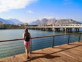 Tourist looks at the bridge on Ataturk Boulevard over Boga Stream river and Taurus Mountains in Antalya, Turkey. Woman with a