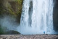 Tourist near Skogafoss waterfall in Iceland