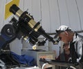 A Tourist Looks Through a Telescope at the Sun