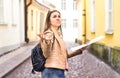 Tourist lost in the city. Confused woman holding map.