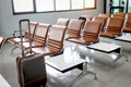 A tourist luggage with empty seats in seat bench row at departure terminal airport, traveler suitcase standing in empty airport,