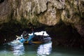 Tourist lying down through small cave, Phang Nga Royalty Free Stock Photo