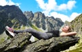 Tourist lying on a rock in Mengusovska Valley, Slovakia