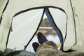 A tourist is lying in a tent. Autumn tourism