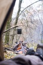 Tourist lying in tent and looking at the fire in the mountain forest Royalty Free Stock Photo