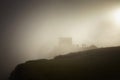 Tourist at Machu Picchu at sunrise in the fog Royalty Free Stock Photo