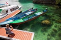 Tourist makes a photo of the boats at the entrance of Piaynemo viewpoint, Raja Ampat , Indonesia