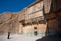 Tourist makes photo of historical landmark - the tomb of persian king Artaxerxes III in historical Persepolis, Iran.