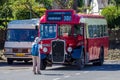 Tourist makes a photograph of an old English bus