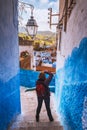 Tourist makes picture of Chefchaouen Blue city of Morocco