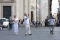 Tourist makes a video of large soap bubbles