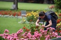 A tourist making a photo in a rosarium