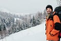 Smiling tourist winter mountain forest landscape