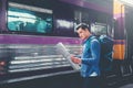 Tourist man backpacker using map to travel at train station Royalty Free Stock Photo