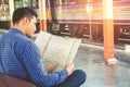 Tourist man backpacker using map to travel at train station Royalty Free Stock Photo