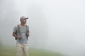 Tourist man backpacker walking alone on nature background Royalty Free Stock Photo