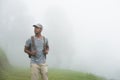 Tourist man backpacker walking alone on nature background Royalty Free Stock Photo