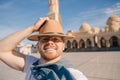 Tourist man in hat takes travel selfie photo background El Mina Masjid mosque in Hurghada, Egypt sunlight