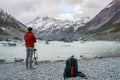 Tourist man with jacket takes photo of Mount Cook by DSLR camera with tripod Royalty Free Stock Photo