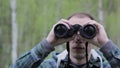 Tourist man looking through binoculars