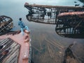 Tourist man looks at the cemetery of old wooden ships Teriberka, Murmansk region, Russia. Aerial top view Royalty Free Stock Photo