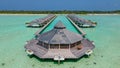 Tourist man at the overwater villas at the beautiful tropical island resort. Sunny day. Aerial photo Royalty Free Stock Photo