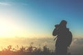 Tourist man shoot photo on peak of mountain