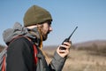 Tourist man speaking on mountain walkie talkie Royalty Free Stock Photo