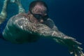 Tourist man in swimming sports glasses swimming underwater in the Aegean Sea on the coast of Sithonia Peninsula Royalty Free Stock Photo