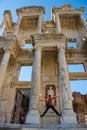 A tourist man is taking Ephesus Celsus Library`s photo